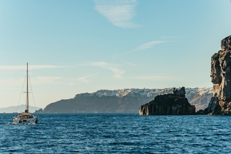 Santorini: Catamaran Caldera Cruise with Meal and Drinks - The landmarks you pass: Black Mountain and the Caldera lighthouse vibe