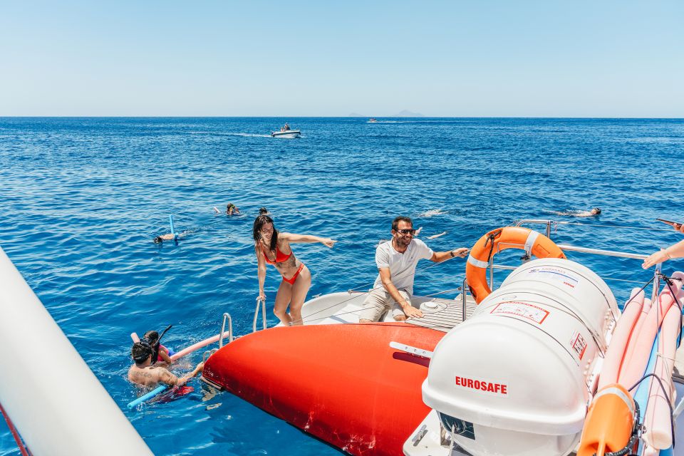 Santorini: Catamaran Tour with BBQ Dinner, Drinks, and Music - A catamaran day that fits Santorini’s pace