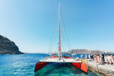 Santorini: Catamaran Tour with BBQ Dinner, Drinks, and Music - The 5-hour flow: hot springs, Red Beach, White Beach, then caldera time