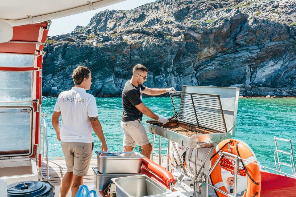 Santorini: Catamaran Tour with BBQ Dinner, Drinks, and Music - White Beach cliffs: the sea-only look that feels special