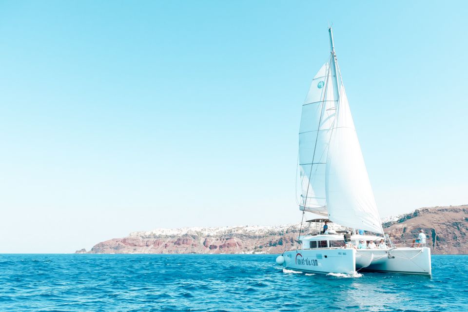 Santorini: Catamaran Tour with BBQ Meal and Unlimited Drinks - Red Beach Snorkeling: Gear Provided, Fish Luck Included
