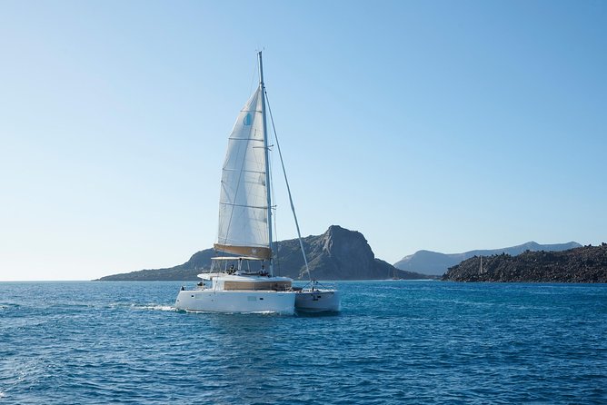 Santorini Platinum Catamaran Cruise with Meal, BBQ and Open Bar - Onboard vibes: small-group comfort, music, and the reality of waves